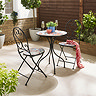 image of wrought iron bistro set with mosaic pattern, on a sunny patio