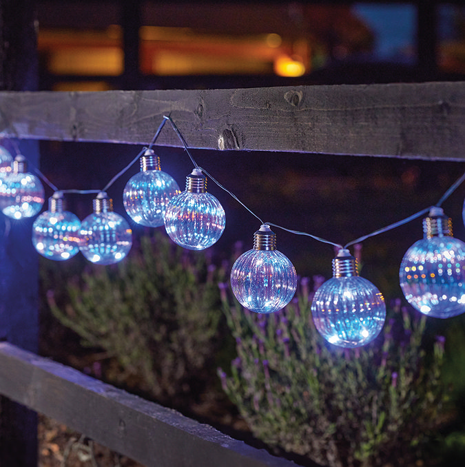image of iridescent opal string lights lit up with blue light at night