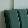 close up image on pleated emerald green velvet headboard of bed