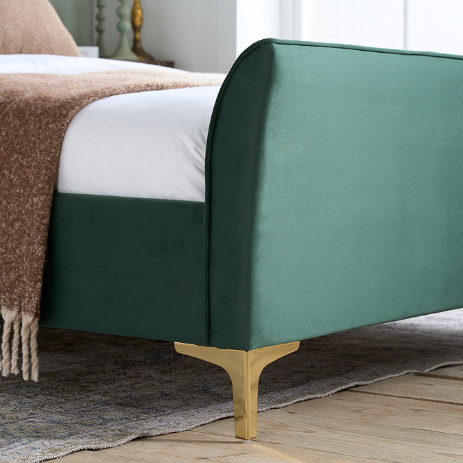 close up image on bottom half of emerald green velvet bed