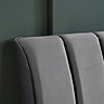 close up on grey velvet pleated headboard of double bed
