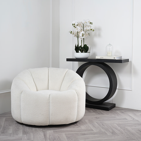 image of ivory swivel chair in boucle fabric next to modern black console table