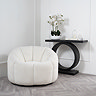 image of ivory swivel chair in boucle fabric next to modern black console table