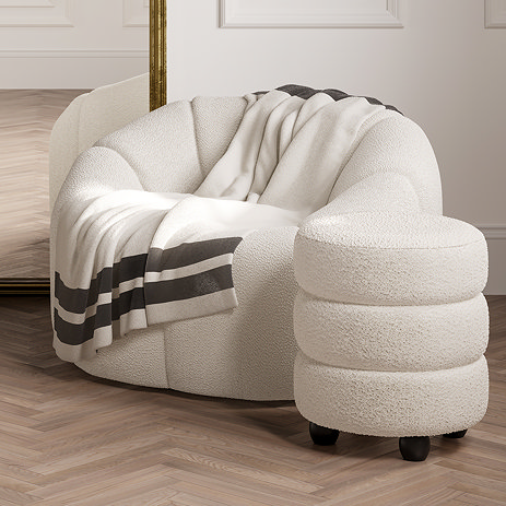 image of ivory boule pouffe with sculptural design, next to matching chair