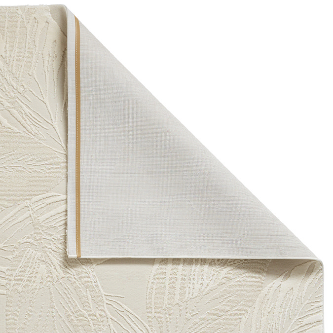 image of cream rug folded over in corner to show floor-facing material underneath