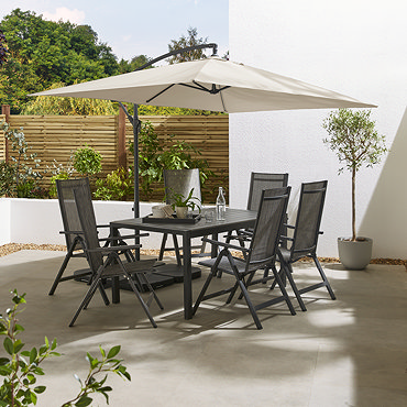 image of rectangular beige parasol over sunny patio with table removed