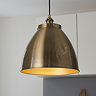 close up image of large antique brass pendant light