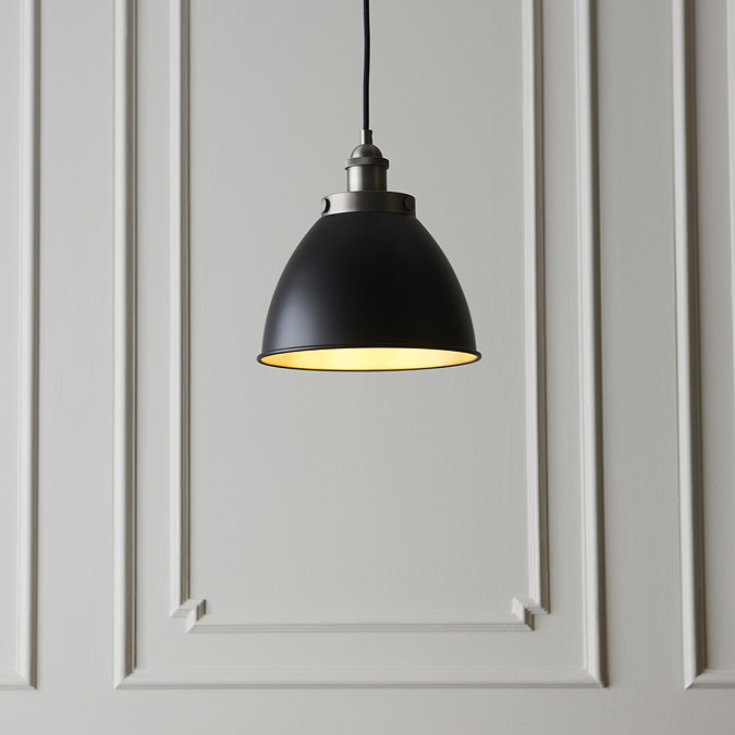 image of black and pewter grey industrial-style pendant lamp hanging against a grey wall