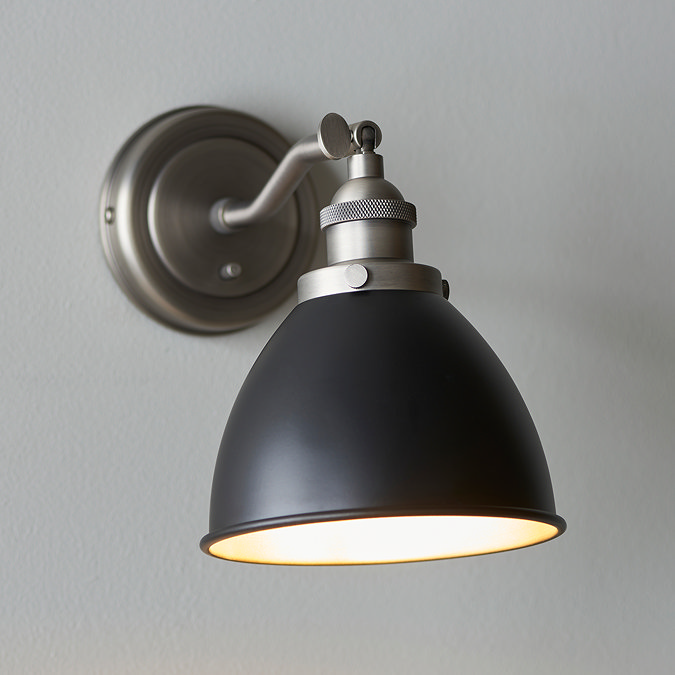 close up image of black and light grey wall light on grey wall