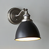 close up image of black and light grey wall light on grey wall