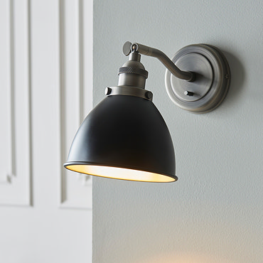 close up image of black and light grey wall light on grey wall