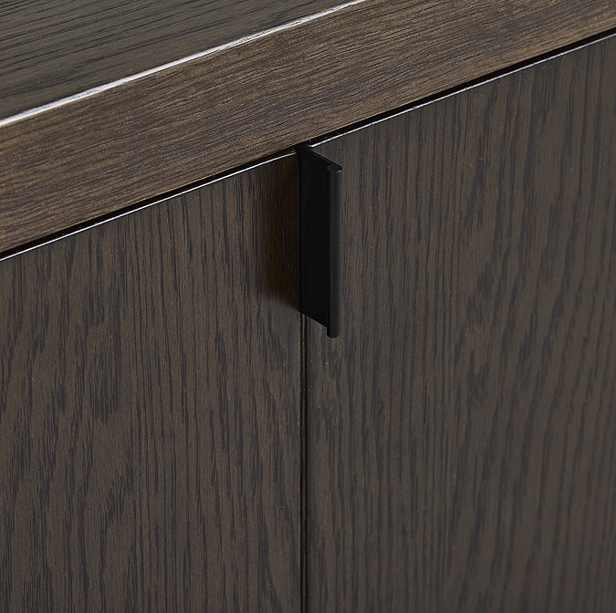close up image of dark oak tv unit with folding doors, highlighting subtle metal handle pull