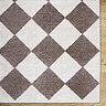 close up image of corner of diamond rug in brown and cream shades