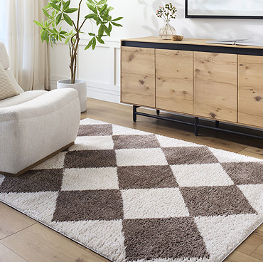close up image of brown diamond rug folded over at corner to reveal material underneath