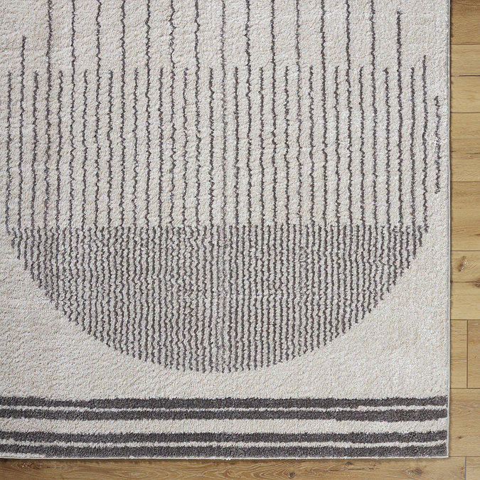 close up image of cream rug with modern grey central circle design