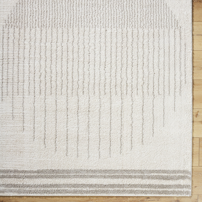 close up image of cream rug with light grey modern circle design