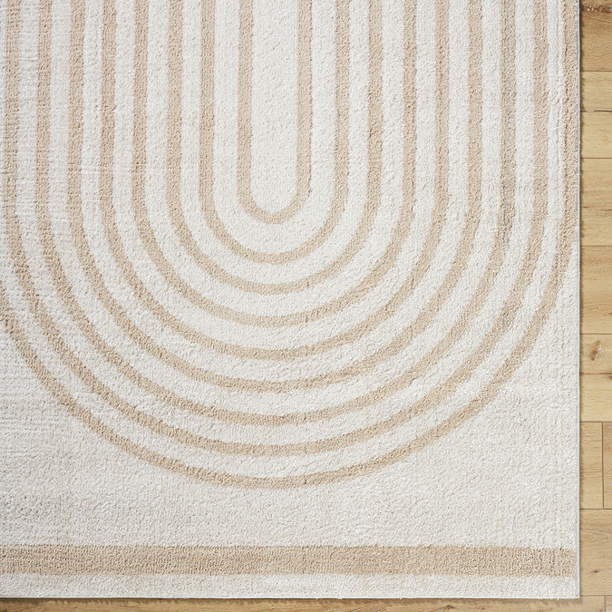close up image of beige and cream lined arch rug