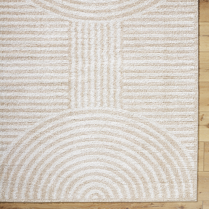 close up image of beige and cream geometric arch rug, focus on colour and texture