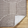 close up image of brown and cream soft rug folded over at the corner to show material underneath