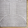 close up image of corner of dark grey lined arch geometric rug