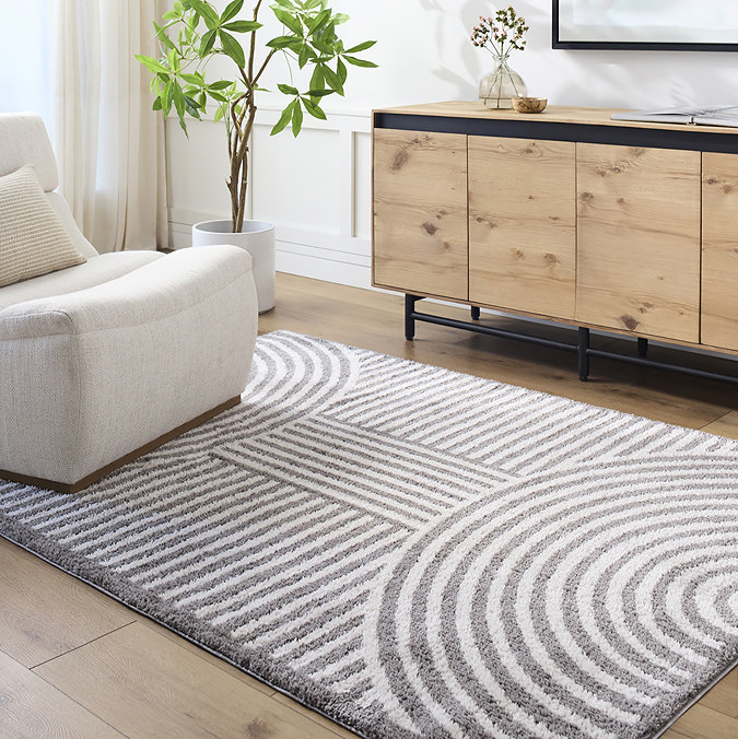 image of dark grey line arch geometric rug on light wood flooring