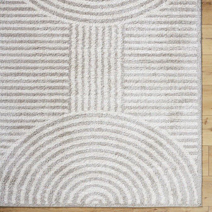 close up image of corner of light grey line arch rug, focus on colour and texture