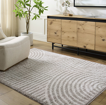 close up image of corner of light grey line arch rug, focus on colour and texture