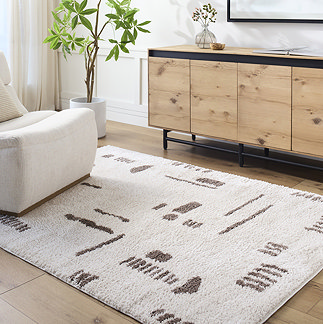 image of cream rug with brown abstract lines, on light wood flooring of living room