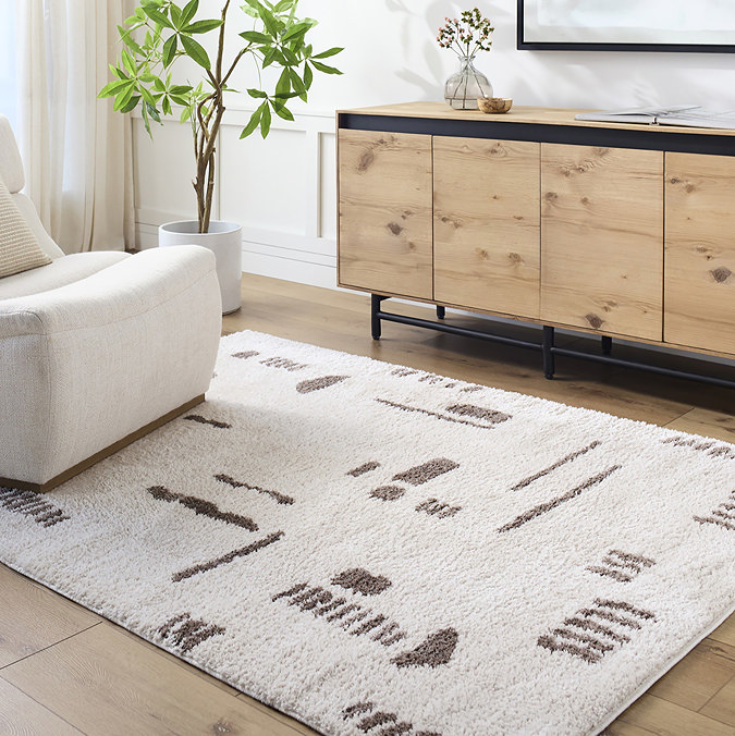 image of cream rug with brown abstract lines, on light wood flooring of living room