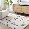 image of cream rug with brown abstract lines, on light wood flooring of living room