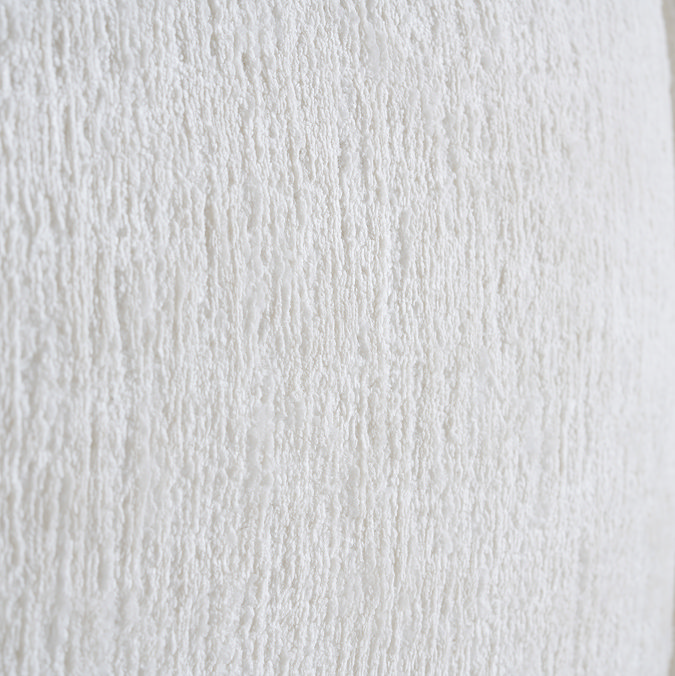close up on cream linen texture of bed headboard