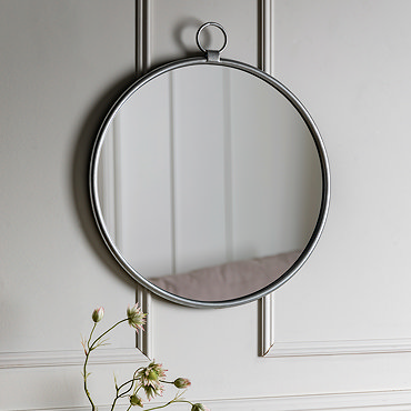 close up image of smooth rounded side of silver wall mounted mirror