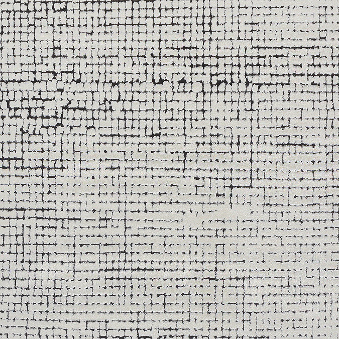 close up swatch image of black and ivory distressed design modern soft rug