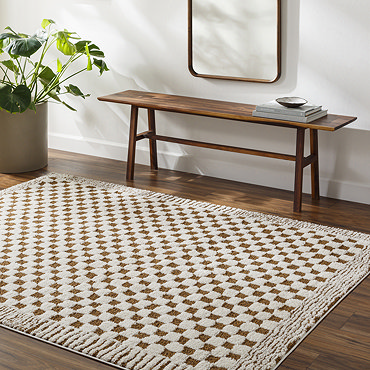 close up image of ivory and brown checkered rug with lined border, ruched up slightly to show thickness
