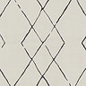 close up swatch image of soft ivory rug with black diamond pattern