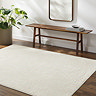 image of ivory rug with subtle geometric pattern, on dark wood flooring