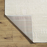 image of ivory rug with subtle geometric pattern, folded in corner to show material underneath
