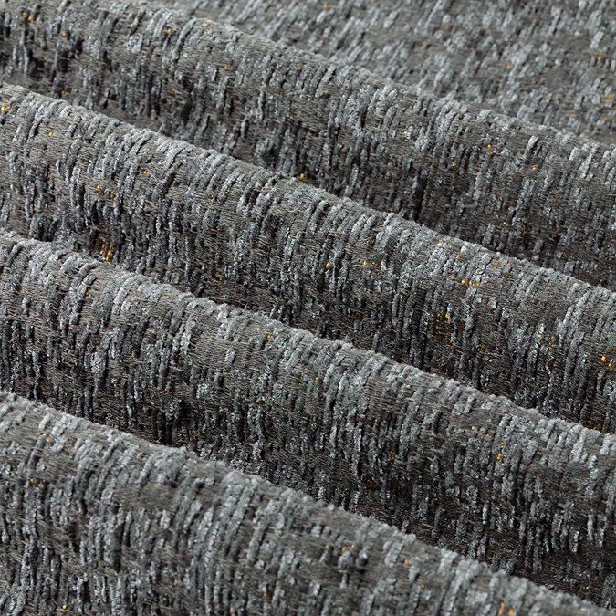 Galaxy charcoal eyelet curtains over a window close up image