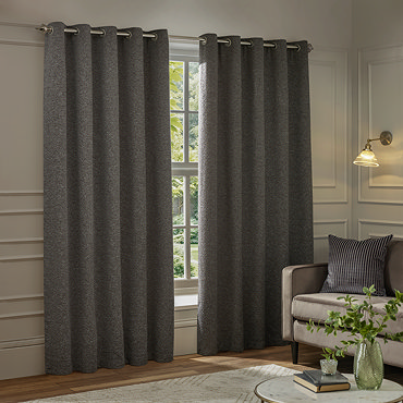 Galaxy charcoal eyelet curtains over a window close up image