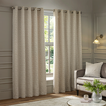 Galaxy Eyelet Curtains in Ivory over a window close up image