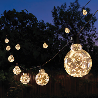 image of ball lights with firefly effect, glowing warm white in garden at night