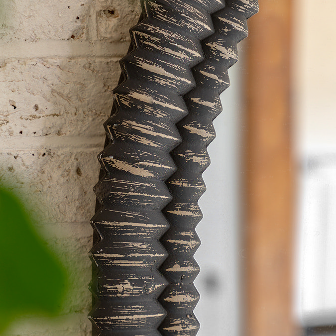 close up image of textured arch of overmantle mirror in blackwash colour