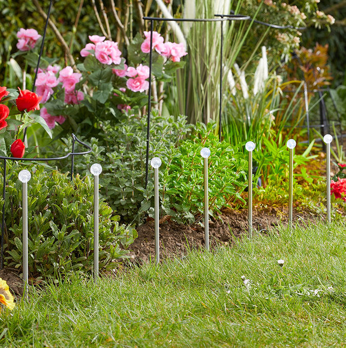 image of 10 acrylic glowball stake lights in garden during the day
