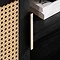 close up on rattan detail of left door of black tv unit