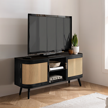close up on shelving section of tv unit, with books and woven storage basket inside