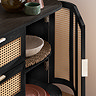 image of right hand door of black rattan sideboard open to show shelving space inside