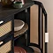 image of right hand door of black rattan sideboard open to show shelving space inside