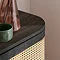 close up image on smooth curved edge of top of black rattan sideboard