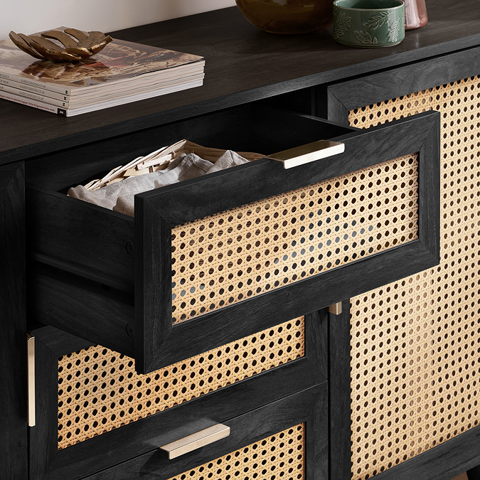 close up image on three drawers in the middle of a 2 door sideboard, with top drawer pulled out