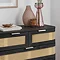 close up image of front of black 5 drawer chest with decorative accessories on top
